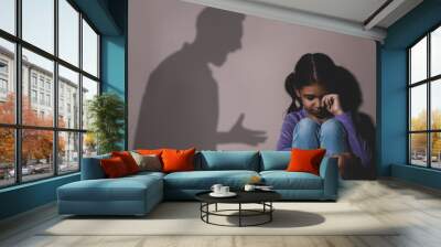 Child abuse. Father yelling at his daughter. Shadow of man on wall Wall mural