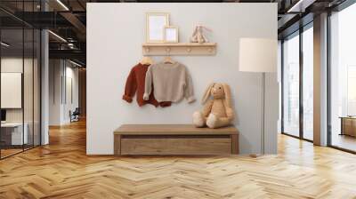 Children's room interior with stylish wooden furniture, baby clothes and lamp Wall mural