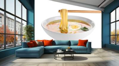 Chopsticks with noodles over bowl of tasty ramen on white background Wall mural