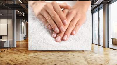 Closeup view of beautiful female hands on towel. Spa treatment Wall mural