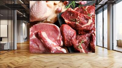 Closeup view of fresh raw meat and herbs on table Wall mural