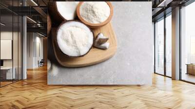 Coconut flour and fresh fruits on light grey table, above view. Space for text Wall mural