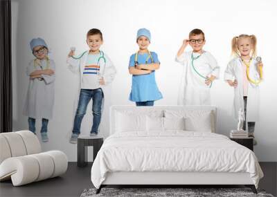 Collage of cute little children wearing doctor uniform costumes on white background. Banner design Wall mural