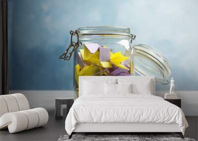 Colorful paper pieces for lottery in glass jar on color background Wall mural