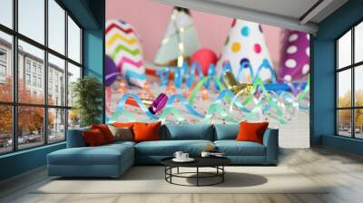 Colorful serpentine streamers and other party accessories on white wooden table, closeup Wall mural