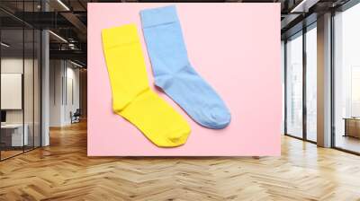 Colorful socks on light pink background, flat lay. Space for text Wall mural