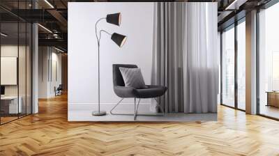 Comfortable armchair with cushion and floor lamp near white wall indoors Wall mural