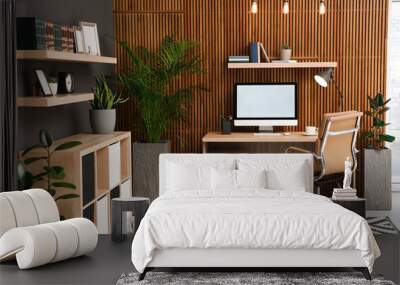 Comfortable workplace with computer near wooden wall in stylish room interior. Home office design Wall mural