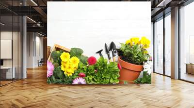 Composition with gardening equipment and flowers on wooden table, top view Wall mural