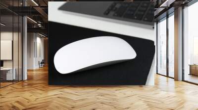 Computer mouse with mousepad and laptop on white table, closeup Wall mural