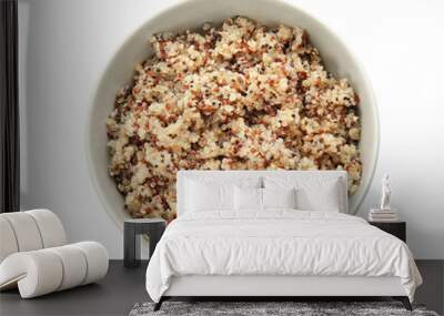 Cooked delicious quinoa in bowl isolated on white, top view Wall mural