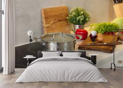 Cooking dinner. Pot and fresh vegetables on countertop in kitchen Wall mural