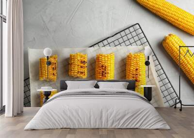 Cooling rack with grilled corn cobs on light background, top view Wall mural