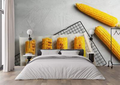 Cooling rack with grilled corn cobs on light background, top view Wall mural