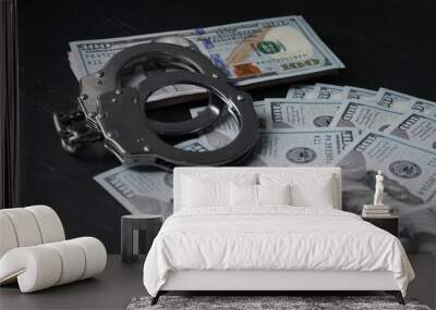 Corruption. Handcuffs and dollar banknotes on black table, closeup Wall mural