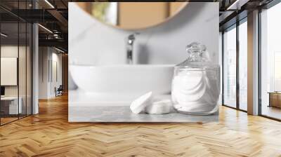 Cotton pads on light grey marble table in bathroom Wall mural