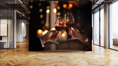 Couple clinking glasses at Valentine's day dinner in restaurant, closeup Wall mural