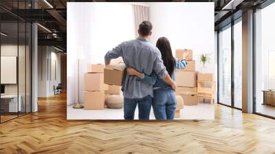 Couple in room with cardboard boxes on moving day Wall mural