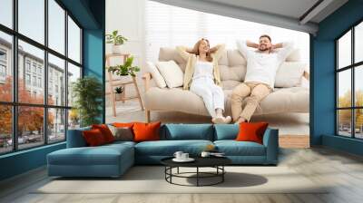 Couple relaxing on sofa in living room Wall mural