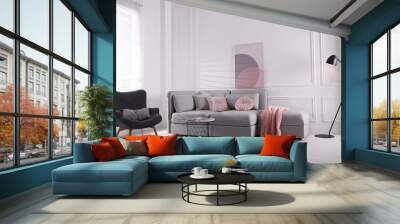 Cozy living room interior with comfortable grey sofa and armchair Wall mural