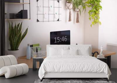 Cozy workplace with computer, modern furniture and houseplants at home Wall mural