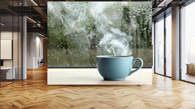 Cup of hot drink near window on rainy day. Space for text Wall mural