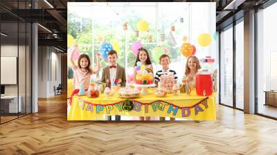 Cute children near table with treats at birthday party indoors Wall mural