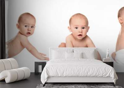 Cute little baby crawling on white background Wall mural