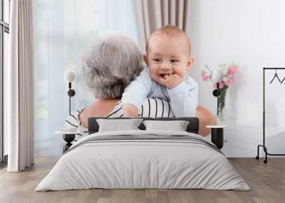 Cute little baby with grandmother at home Wall mural