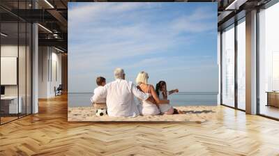 Cute little children with grandparents spending time together on sea beach, back view Wall mural