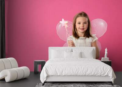 Cute little girl in fairy costume with wings and magic wand on pink background. Space for text Wall mural