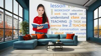 Cute little girl reading vocabulary on white background with word cloud Wall mural