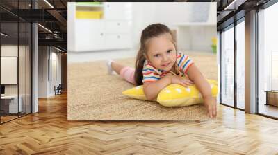 Cute little girl with soft pillow toy on floor at home, space for text Wall mural