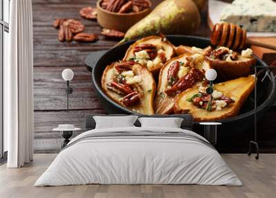 Delicious baked pears with nuts, blue cheese and honey on wooden table, closeup Wall mural