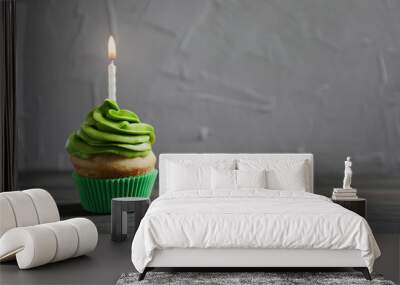 delicious birthday cupcake with burning candle on table Wall mural