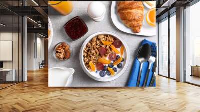 Delicious breakfast with granola served on white table, flat lay Wall mural