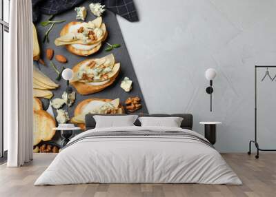 Delicious bruschettas with cheese, pear and nuts on grey table, flat lay. Space for text Wall mural