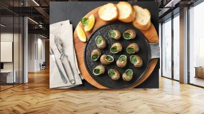 Delicious cooked snails served on grey textured table, flat lay Wall mural