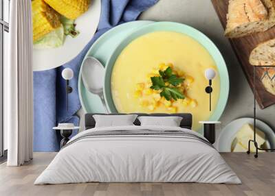 Delicious corn cream soup served on light grey table, flat lay Wall mural