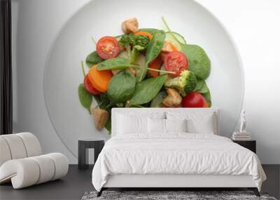 Delicious fresh chicken salad with vegetables and spinach isolated on white, top view Wall mural