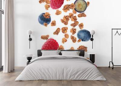 Delicious granola and berries falling on white background. Healthy snack Wall mural