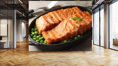 Delicious grilled salmon fillets with green peas in baking dish served on grey textured table, closeup Wall mural