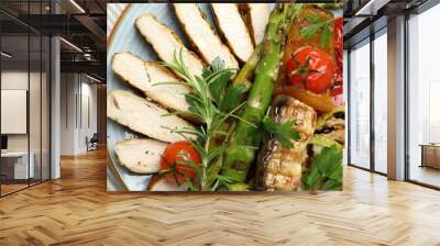 Delicious grilled vegetables and cut chicken meat on table, top view Wall mural