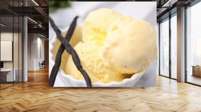 Delicious ice cream and vanilla pods on white table, closeup Wall mural