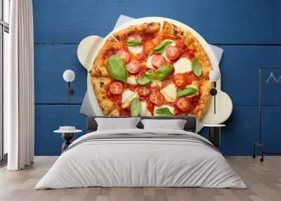 Delicious Margherita pizza on blue wooden table, top view Wall mural