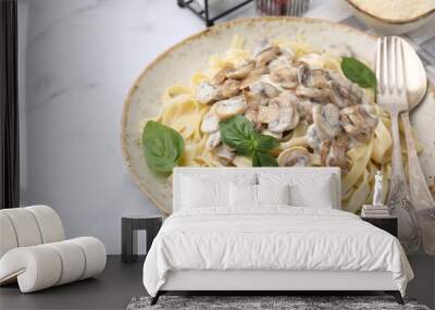 Delicious pasta with mushrooms and basil served on white marble table, closeup Wall mural