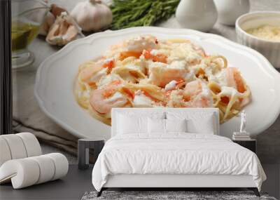 Delicious pasta with shrimps served on light table, closeup Wall mural