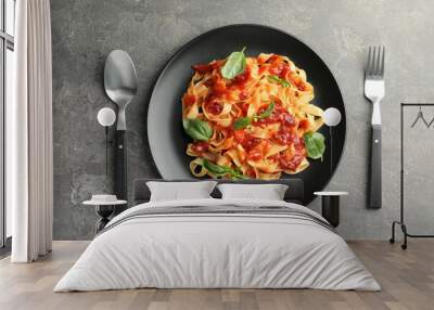 Delicious pasta with tomato sauce and basil served on grey textured table, flat lay Wall mural