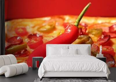 Delicious pizza Diablo and chili pepper against red background, closeup Wall mural