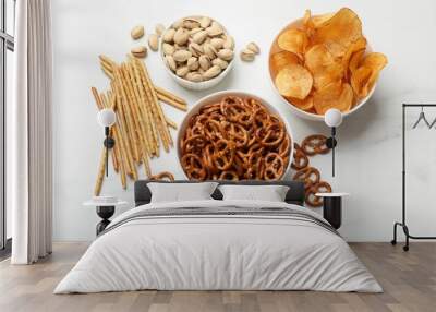 Delicious pretzel crackers and other snacks on white table, flat lay Wall mural